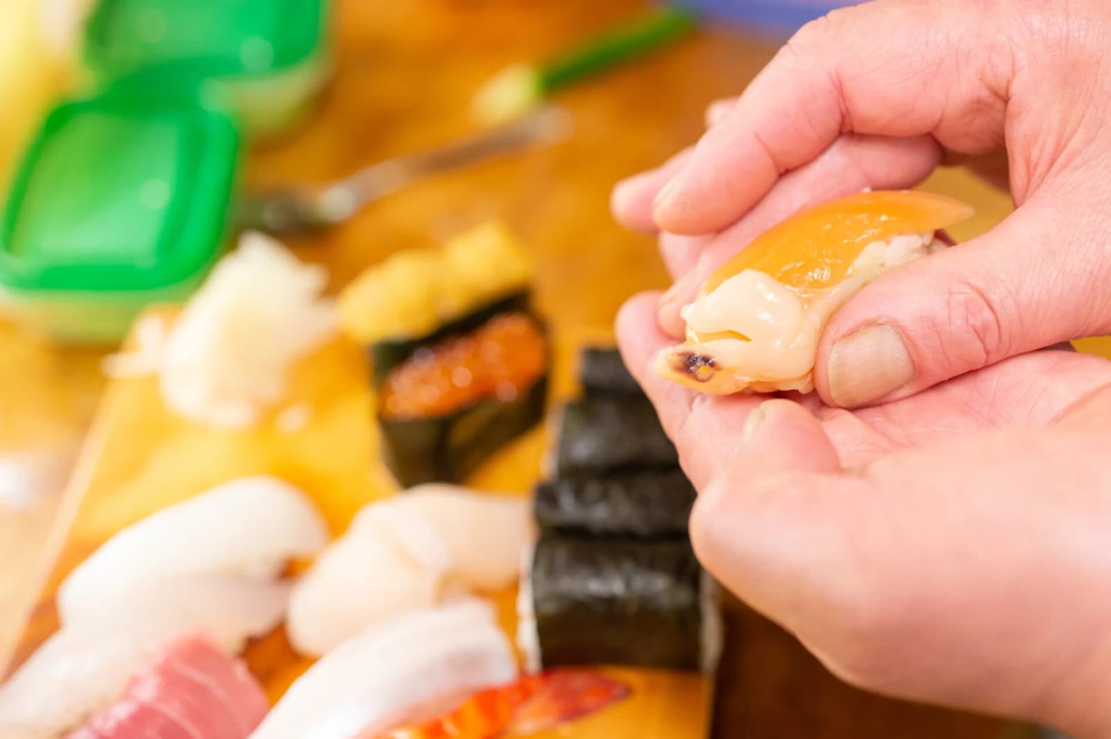 A chef shaping sushi at Sushi Katsu’s counter